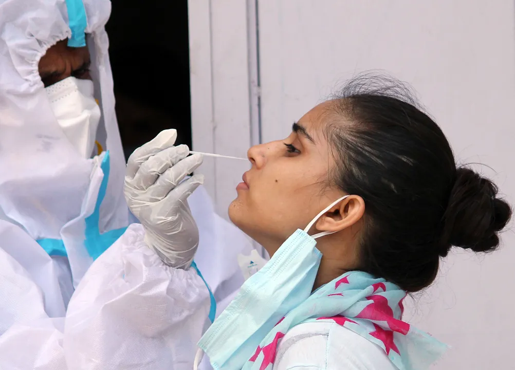  Haryana, June 26 (ANI): A health worker collects a nasal sample for Covid-19 Ag rapid antigen testing at Chakkarpur Community Centre, near DLF Phase 4, in Gurugram on Friday. (ANI Photo) 