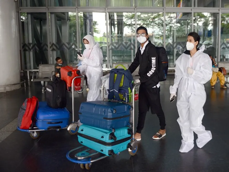  West Bengal, July 18 (ANI): Passengers wearing PPE kit arrive at Netaji Subhash Chandra Bose International Airport, in Kolkata on Saturday. Kolkata will not allow passengers on flights from Delhi, Mumbai, Nagpur, Pune, Chennai, and Ahmedabad from July 6 to July 19 due to a rising number of COVID-19 cases. (ANI Photo) 