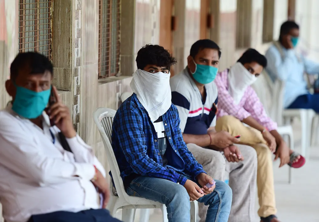  People wait to get tested for COVID-19 outside a testing facility in Allahabad, India, on Aug.  7, 2020. 