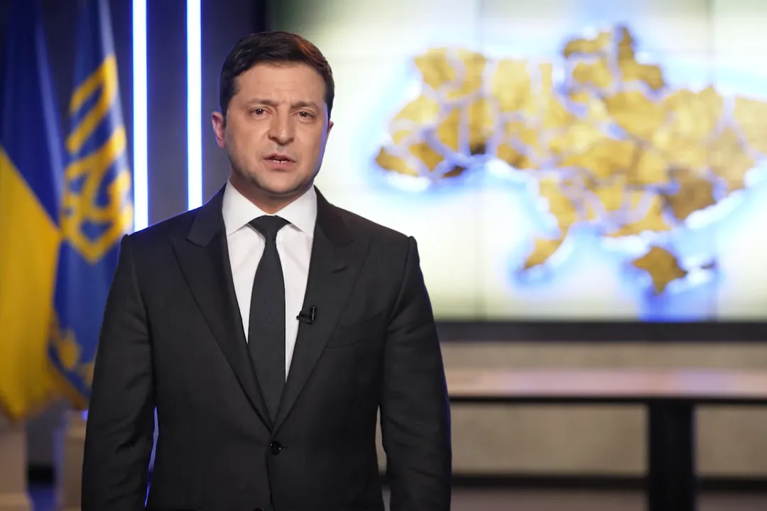  In this handout photo taken from video provided by the Ukrainian Presidential Press Office, Ukrainian President Volodymyr Zelenskyy addresses the nation in Kyiv, Ukraine, Thursday, Feb. 24, 2022. Zelenskyy declared martial law, saying Russia has targeted Ukraine's military infrastructure. He urged Ukrainians to stay home and not to panic. (Ukrainian Presidential Press Office via AP) 
