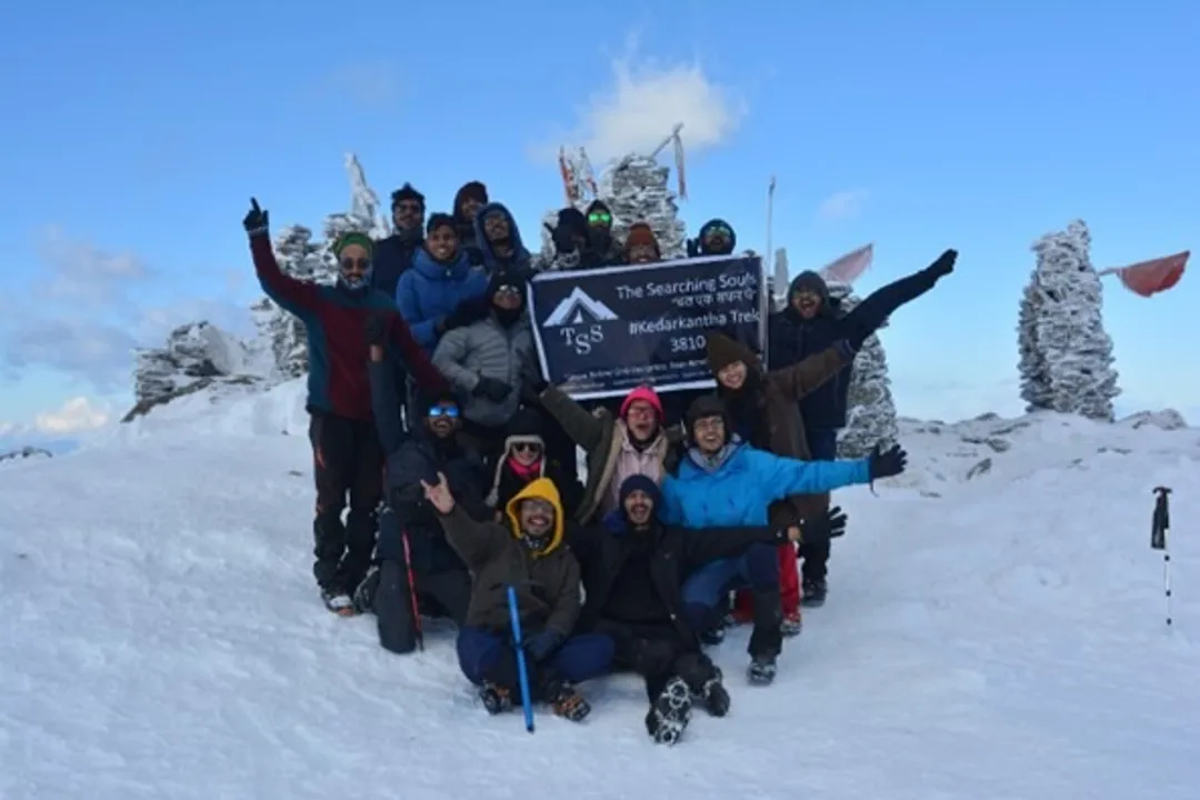 A trekker overlooking the Himalayan range with a map and digital planning interface