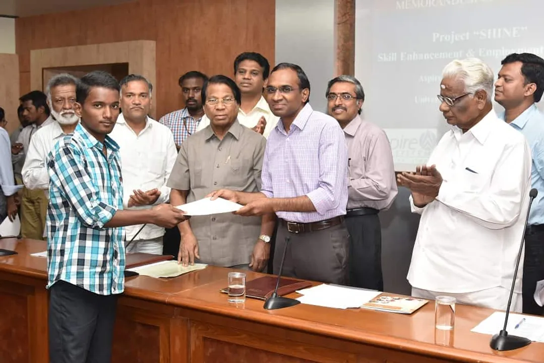 Gowri Shankar Subramanian CEO Aspire Systems handing over the admission letter for the SHINE program to one of the candidates