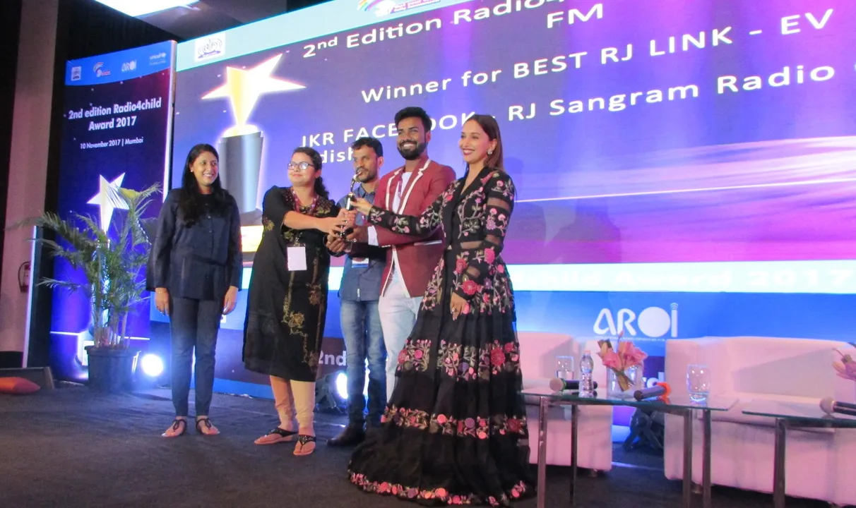  (R-L) Madhuri Dixit giving away the award for Best Public Service Announcement on EndViolence-FM to RJ Niel, sound engineer Srikant and RJ Komal 