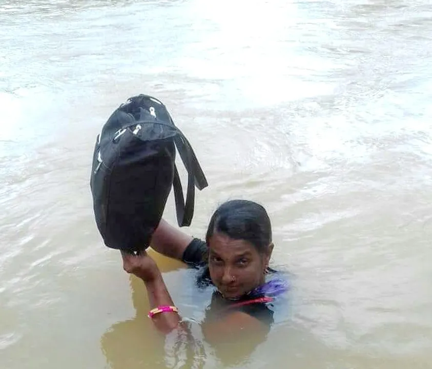  Odisha: A teacher who swims neck-deep water to reach school everyday!