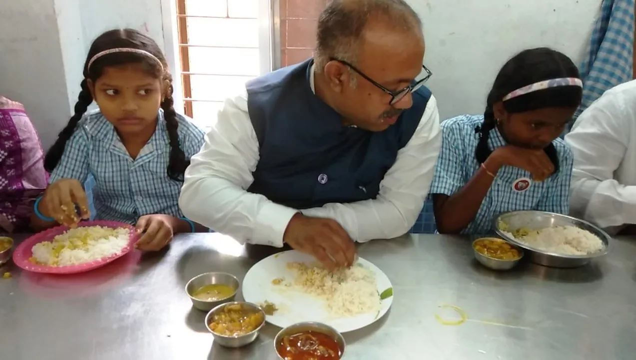  Viral: Odisha minister having chicken curry in mid-day meal