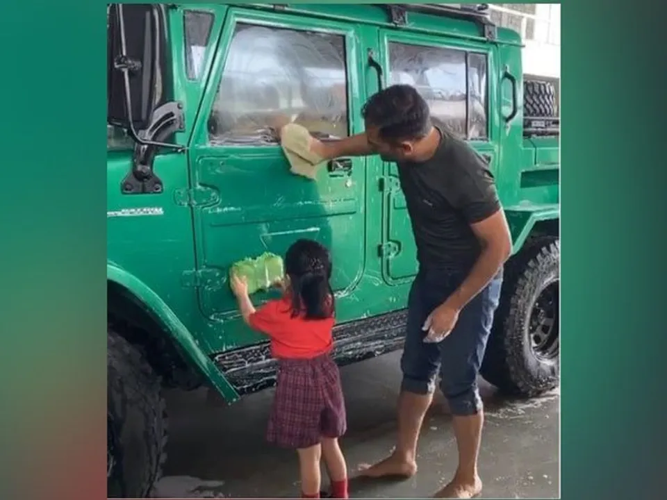  Dhoni gets help from daughter Ziva as they wash his new car