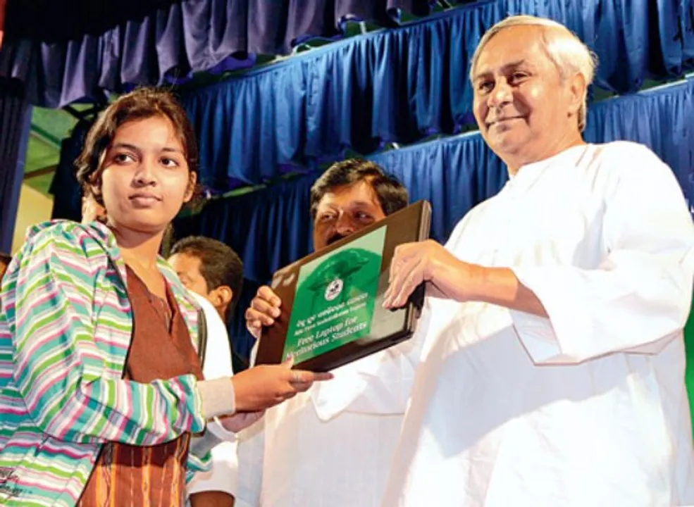 Chief Minister Naveen Patnaik distributes free laptop to a student at a programme (File Photo)  