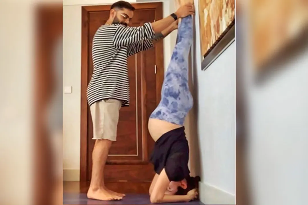  Pregnant Anushka Sharma performs Shirshasana with Virat's support