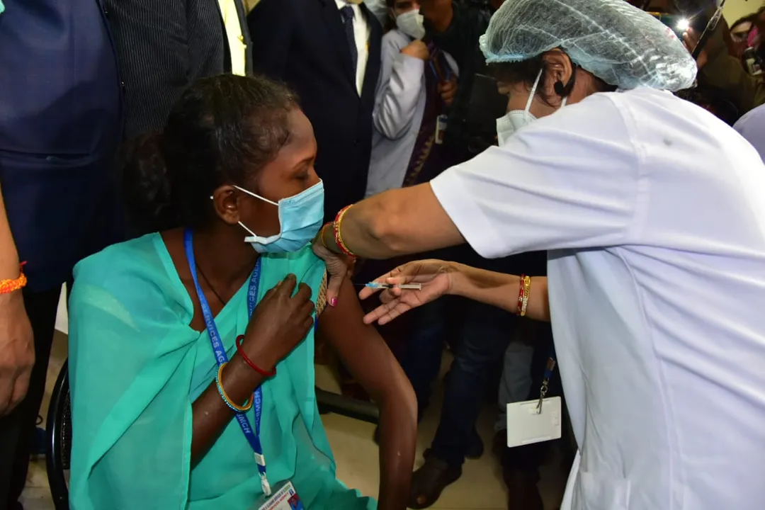  Sanitation worker Barsha Dei getting first shot of COVID-19 at SCB Medical College & Hospital, Cuttack.  