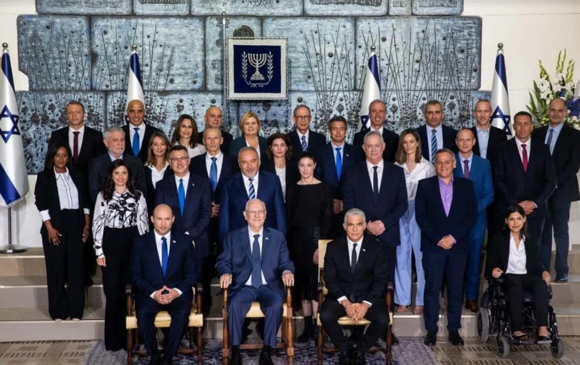  The new Israeli Prime Minister Naftali Bennett (L, front row), Israeli President Reuven Rivlin (C, front row) and Alternate Prime Minister and Foreign Minister Yair Lapid (R, front row) pose for a group photo with the new government ministers at the President's residence in Jerusalem, June 14, 2021. (JINI via Xinhua) 