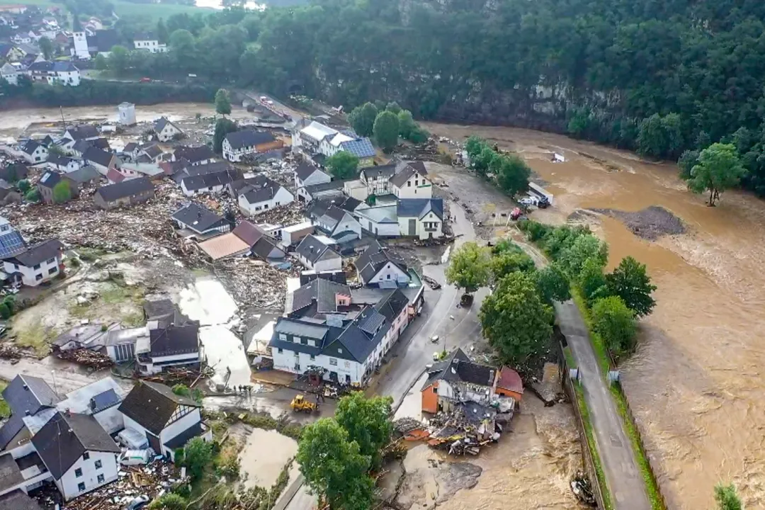  Aerial view taken on July 15, 2021 shows the flooded village of Schuld, near Adenau, western Germany, after heavy rains and floods caused damages and teared down at least six houses and doezens of people went missing. - Heavy rains and floods lashing western Germany have killed at least nine people and left around 50 missing, as rising waters led several houses to collapse, police said on on July 15, 2021. (Photo by Christoph Reichwein / dpa / AFP) / Germany OUT 