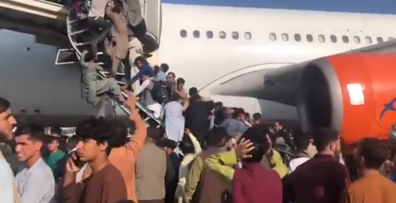  Watch: Afghans scale jet bridge to push their way onto plane at Kabul airport