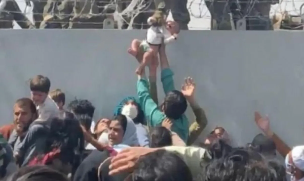  Baby passed over wall at Kabul airport reunited with family