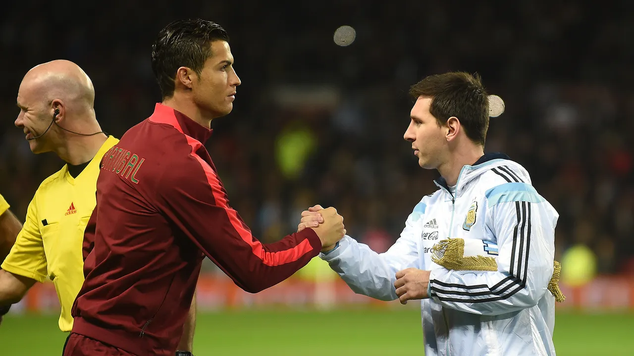  Argentina striker Lionel Messi (R) shakes hands with Portugal's striker Cristiano Ronaldo (L) ahead of kick off of the international friendly football match between the Argentina and Portugal at Old Trafford in Manchester on November 18, 2014. AFP PHOTO / PAUL ELLIS        (Photo credit should read PAUL ELLIS/AFP/Getty Images) 