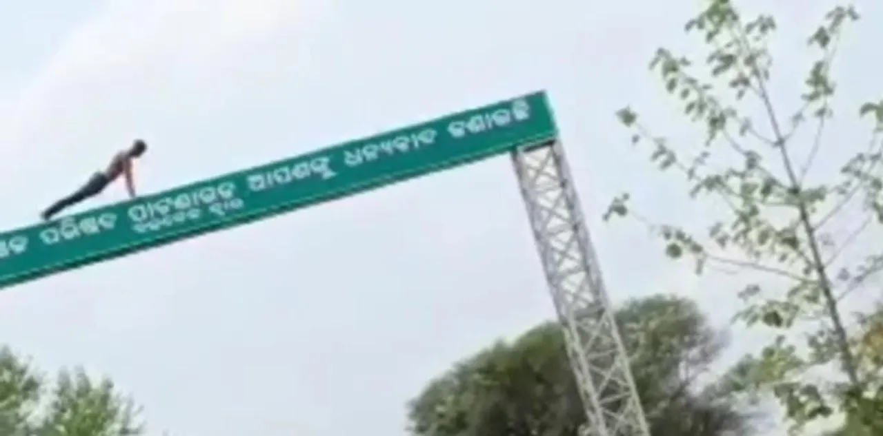  Youth's stunt atop NAC entrance gate goes viral in Odisha's Balangir: Watch video here