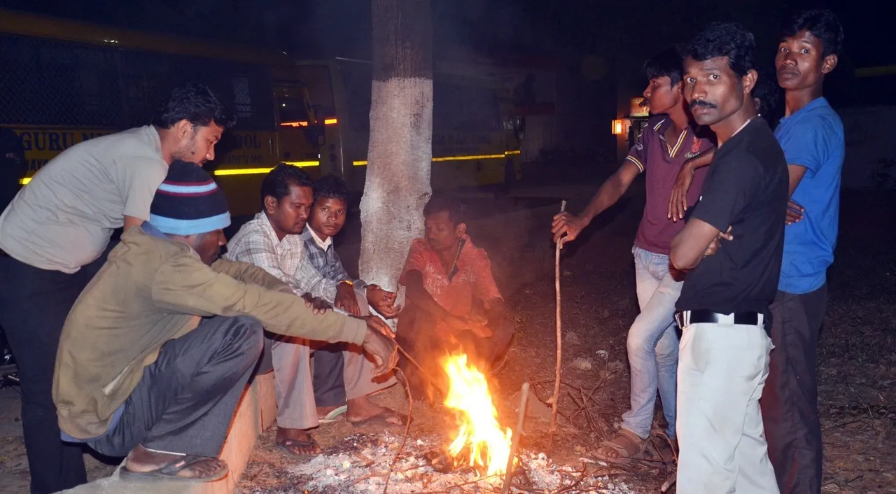  People in Rourkela setting near fire for relief from winter. Photo: sambad.in  