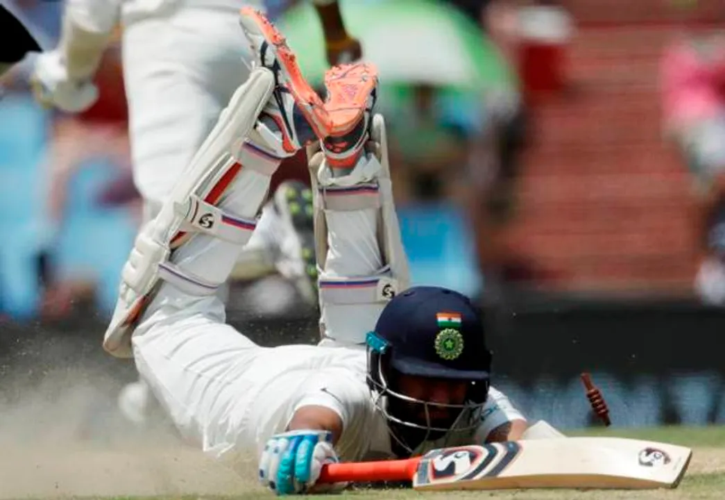  India’s batsman Cheteshwar Pujara, dives unsuccessful to avoid a run out by South Africa’s fielder Lungi Ngidi, during the second day of the second cricket test match between South Africa and India at Centurion Park in Pretoria, South Africa, Sunday, Jan. 14, 2018. (AP Photo/Themba Hadebe) 