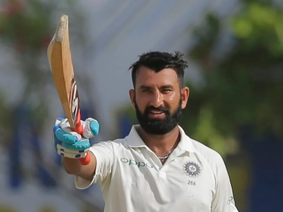  India's Cheteshwar Pujara celebrates scoring a century during the first day's play of the first test cricket match between India and Sri Lanka in Galle, Sri Lanka, Wednesday, July 26, 2017. (AP Photo/Eranga Jayawardena) 