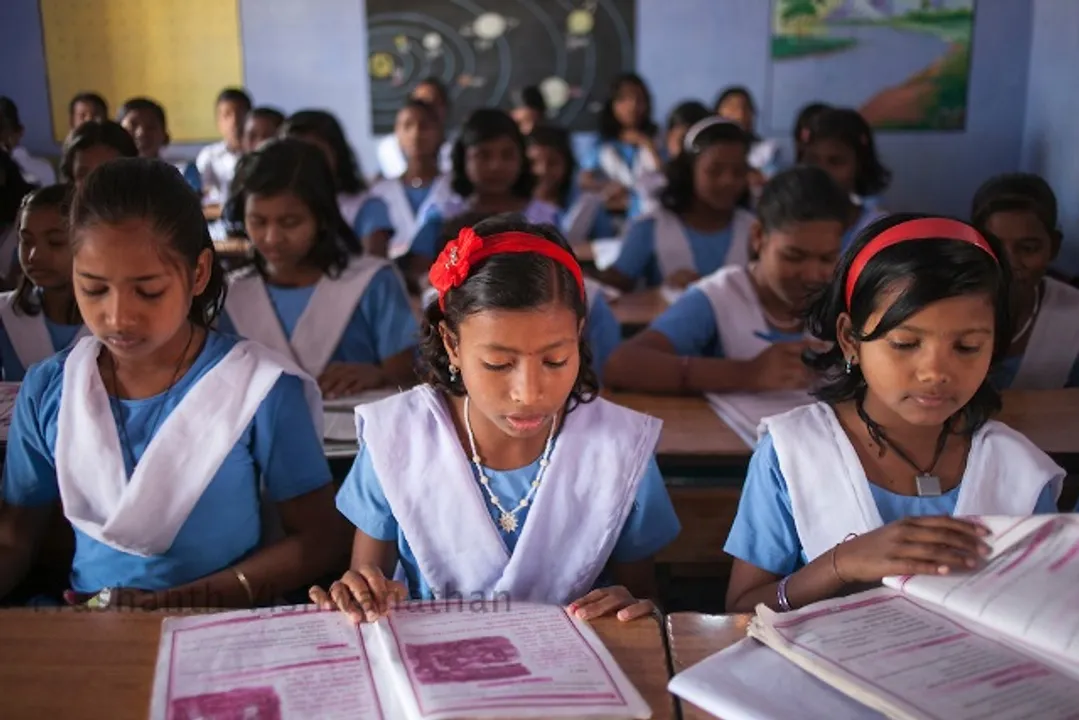  Village: Baluka, Keonjhar, Odisha, India, 6 March 2013:
Students read their books during class hours at Baluka UG UP school in Keonjhar. 
School Students Helpline and SAMIKSHA ( analysis) are monitoring and feedback tools, implemented by Odhisa Government for effective implementation of the Right to Education Act in Odhisa. UNICEF India/2013/Prashanth Vishwanathan 