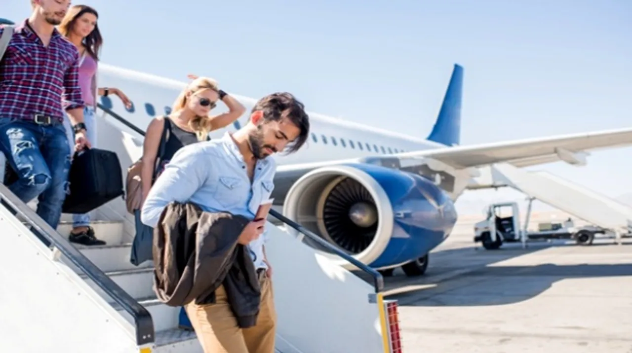  Young passengers getting out of the airplane. 