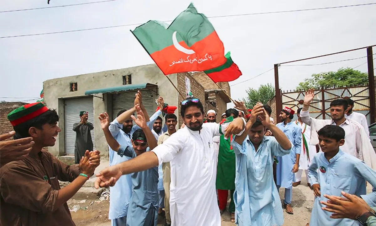  Supporters of Pakistani politician Imran Khan, chief of the Pakistan Tehreek-e-Insaf party, dance to celebrate the victory of their party candidate, in Peshawar, Pakistan, Thursday, July 26, 2018. Pakistan's former cricket star Imran Khan and his party were maintaining a commanding lead Thursday amid slow and tedious counting of ballots from a historic election. Election officials said an official count confirming Pakistan's next government was expected later in the evening. (AP Photo/Mohammad Sajjad) 