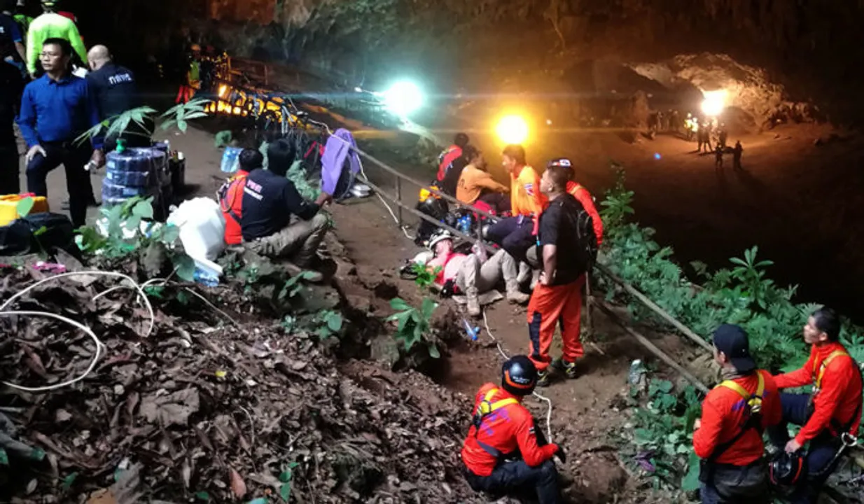  epa06838612 Thai rescue workers and park officials rest outside the Tham Luang Nang Non cave, as the authorities search for 12 football players and their coach who have gone missing and are believed to be trapped in Tham Luang Nang Non cave at Mae Sai district, Chiang Rai province, northern Thailand, 25 June 2018. At least 12 members of a youth football team have gone missing and are believed to be trapped in cave of Mae Sai district. All they enter the cave after the players training on 23 June. They may have been cut off by rising flood water in the cave, a tourist service official said.  EPA/CHAICHAN CHAIMUN 