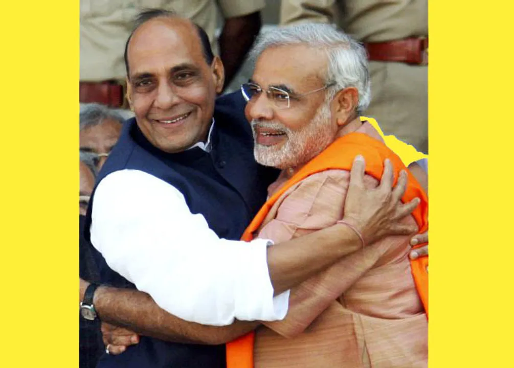  The President of Bharatiya Janata Party (BJP), Rajnath Singh (L) embraces Gujarat's Chief Minister Narendra Modi after the swearing in ceremony at a stadium in the western Indian city of Ahmedabad December 25, 2007. Modi formally took power as chief minister of Gujarat on Tuesday, after a strong election victory that came as a shot in the arm for the BJP. REUTERS/Amit Dave (INDIA) - RTX4ZWO 