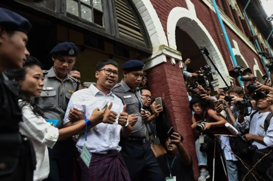  Detained Myanmar journalist Wa Lone (C) is escorted by police out of a court in Yangon on August 27, 2018. - A Myanmar court on August 27 postponed ruling on whether two Reuters journalists violated a state secrets law while reporting on the Rohingya crisis, with a new date set for next week. (Photo by Ye Aung THU / AFP)YE AUNG THU/AFP/Getty Images 