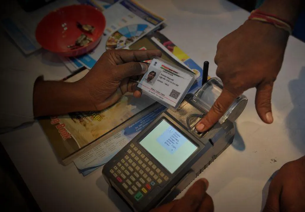  (FILES) This file photo taken on January 18, 2017 shows an Indian visitor giving a thumb impression to withdraw money from his bank account with his Aadhaar or Unique Identification (UID) card during a Digi Dhan Mela, held to promote digital payment, in Hyderabad.
India's Supreme Court ruled August 24 that citizens have a constitutional right to privacy, a landmark verdict that could have wide-reaching implications for the government's biometric programme which holds data on over one billion people.
 / AFP PHOTO / Noah SEELAM 