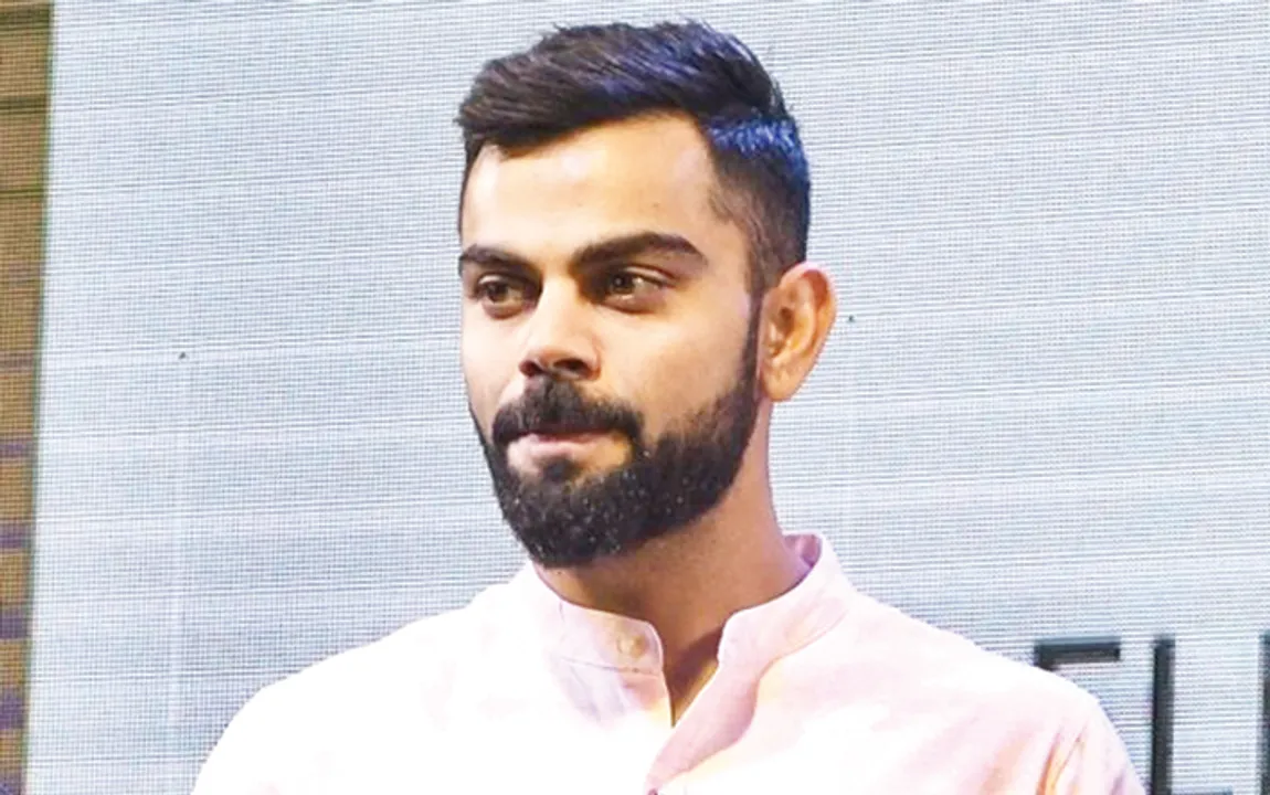 Kolkata: Journalist Boria Majumdar with Indian cricket team's captain Virat Kohli, Cricket Association of Bengal (CAB) President Sourav Ganguly and other dignitaries during the launch of his book 'Eleven Gods and a Billion Indians' in Kolkata on April 7, 2018. (Photo: Kuntal Chakrabarty/IANS) 