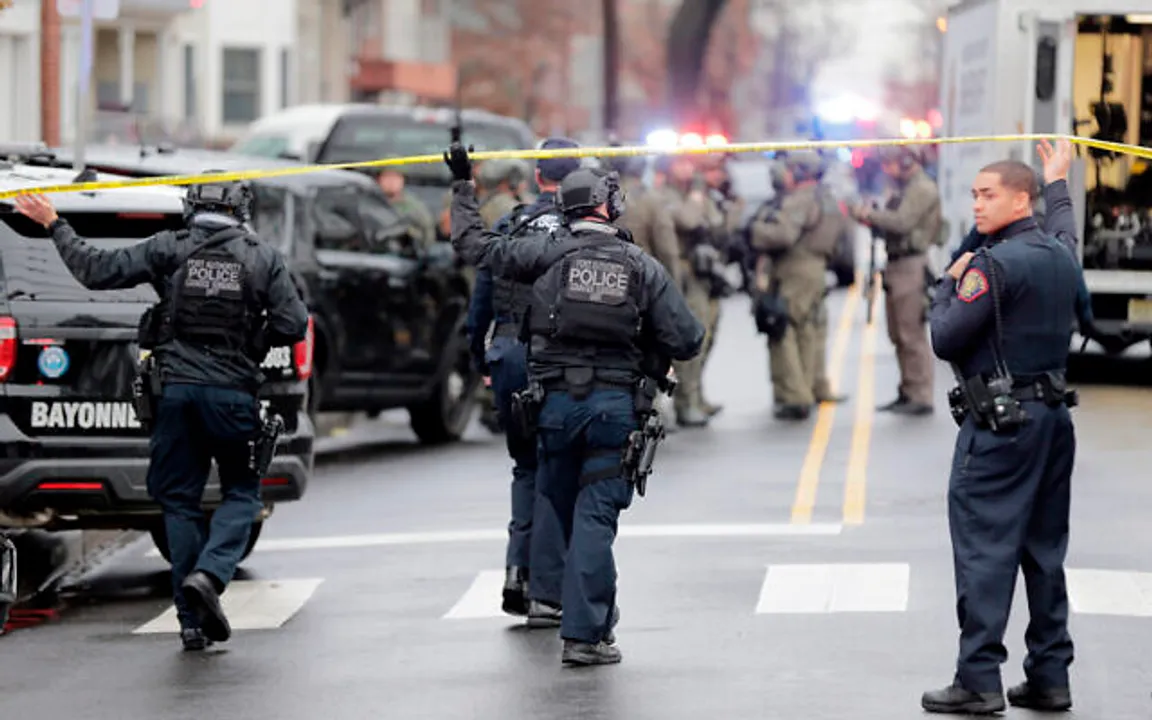  Port Authority Police officers arrive at the scene following reports of gunfire, Tuesday, Dec. 10, 2019, in Jersey City, N.J.  (AP Photo/Seth Wenig) 