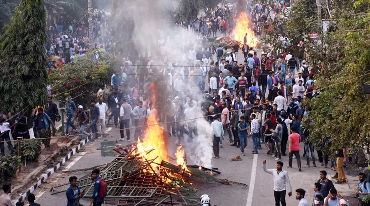 Assam, Dec 11 (ANI): Protestors burn hoarding and wood during their protest strike against the Citizenship Amendment Bill (CAB), in Guwahati on Wednesday. (ANI Photo) 
