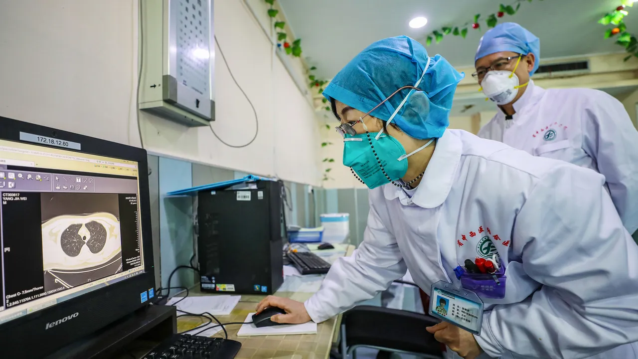  A doctor wearing a face mask looks at a CT image of a lung of a patient at a hospital in Wuhan, China. 