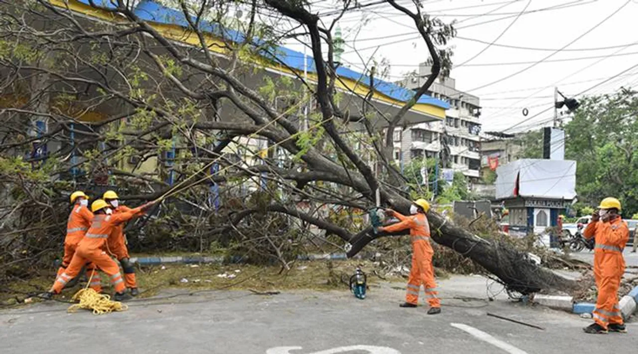  Kolkata: NDRF personnel work to clear an uprooted tree from a road, in the aftermath of Cyclone Amphan, in Kolkata, Tuesday, May 26, 2020. (PTI Photo/Swapan Mahapatra)(PTI26-05-2020_000113A) 