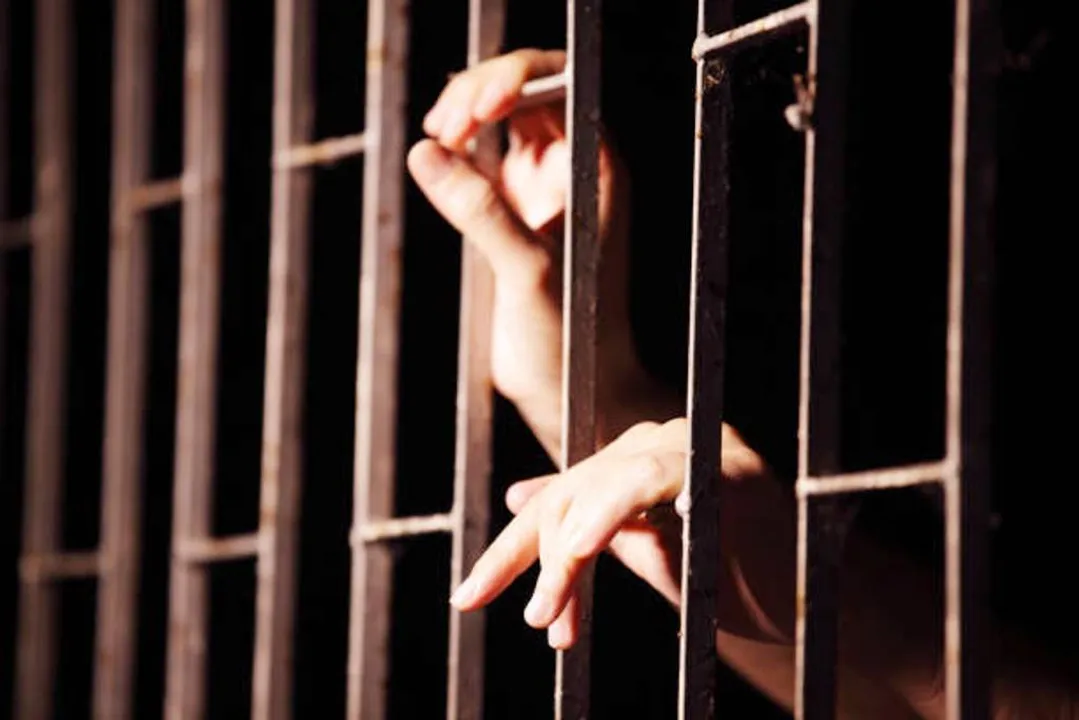  close up of hands in jail background. 
