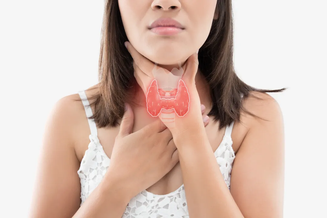  The photo of thyroid is on the human body, Women thyroid gland control. Sore throat of a people against gray background. 