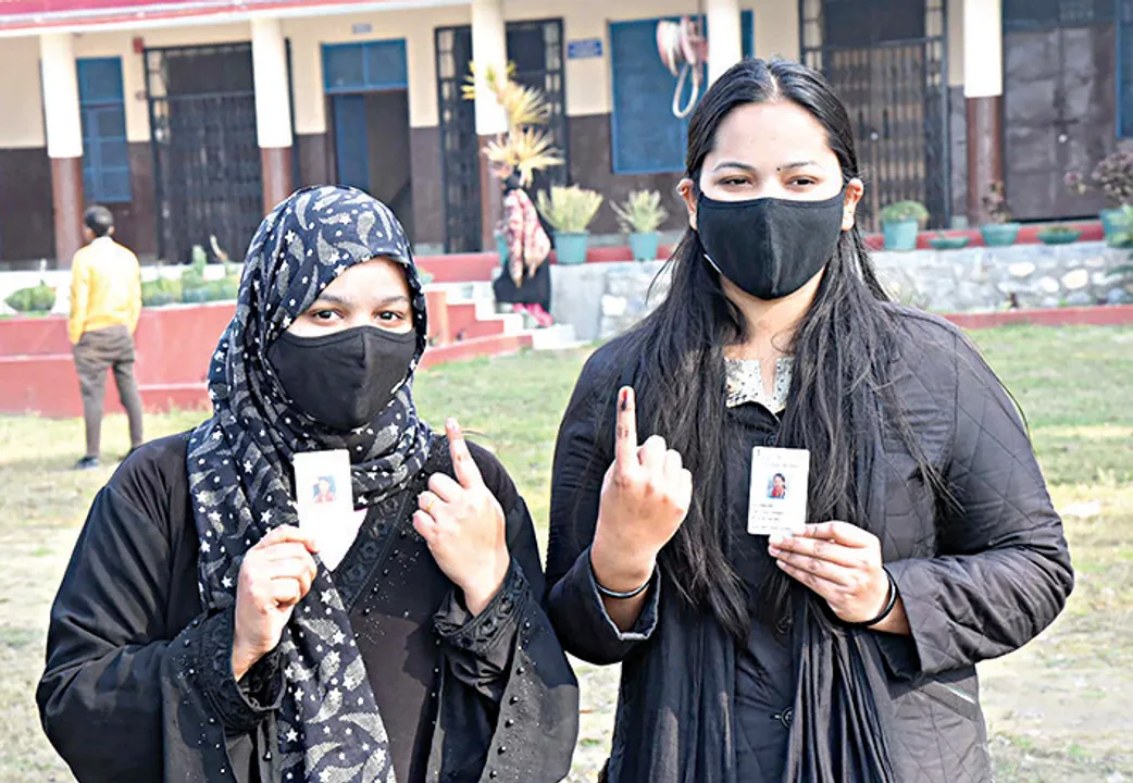  Voter showing mark of indelible ink after casting their votes, at a polling booth, during the Uttarakhand Assembly Election, at Shri Guru Ram Rai Public School, in Dehradun, Uttarakhand on February 14, 2022. 