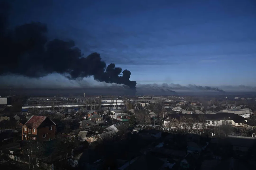  TOPSHOT - Black smoke rises from a military airport in Chuguyev near Kharkiv  on February 24, 2022. - Russian President Vladimir Putin announced a military operation in Ukraine today with explosions heard soon after across the country and its foreign minister warning a "full-scale invasion" was underway. (Photo by Aris Messinis / AFP) (Photo by ARIS MESSINIS/AFP via Getty Images) 