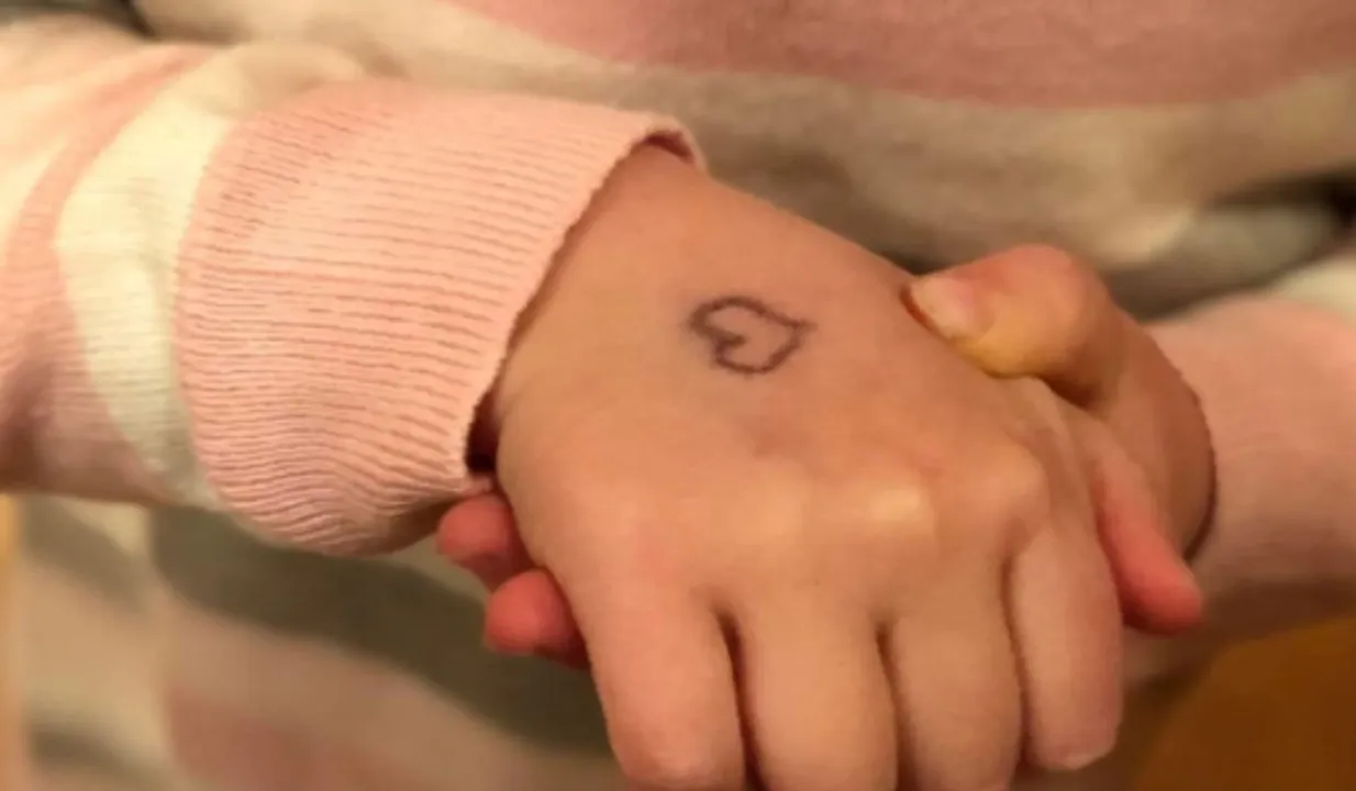 Mom Draws Heart On Kid Hand