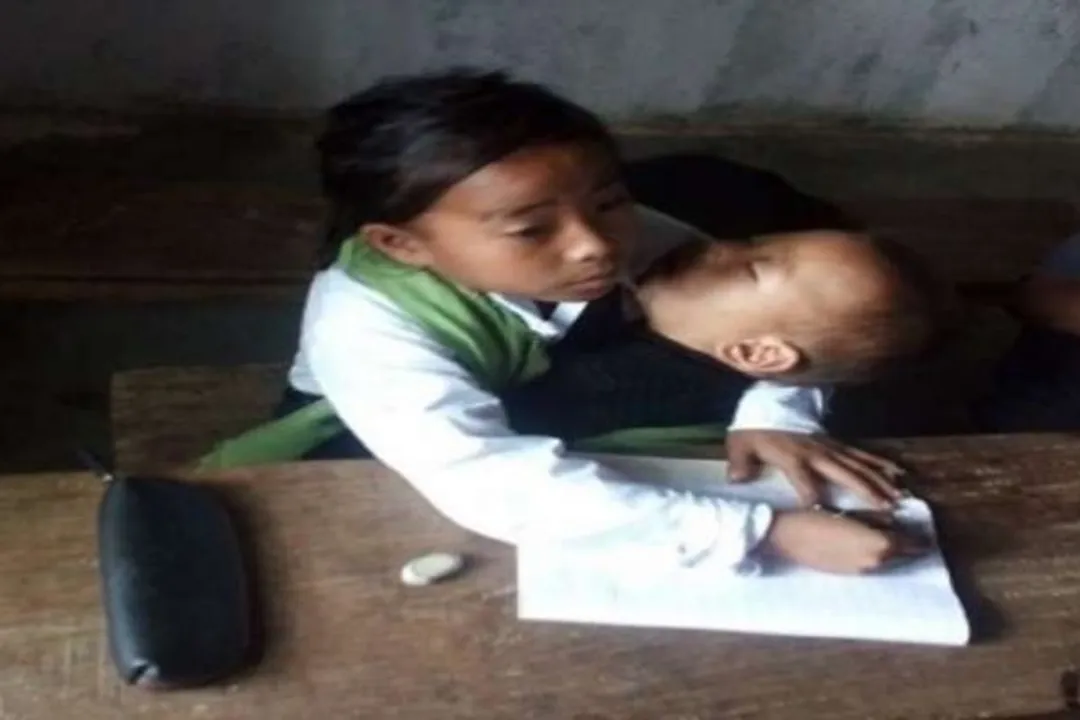 Manipur Girl Babysits Her Sister, Manipur girl babysits sister in class, Girl Babysits Her Sister