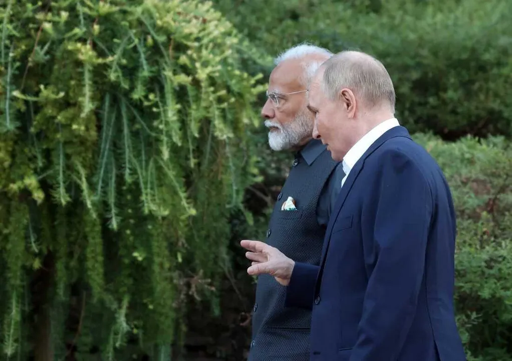  In this pool photograph distributed by the Russian state agency Sputnik, Russia's President Vladimir Putin and Indian Prime Minister Narendra Modi take a walk during an informal meeting at the Novo-Ogaryovo state residence, outside Moscow, on July 8, 2024. (Photo by Sergei KARPUKHIN / POOL / AFP) (Photo by SERGEI KARPUKHIN/POOL/AFP via Getty Images) 