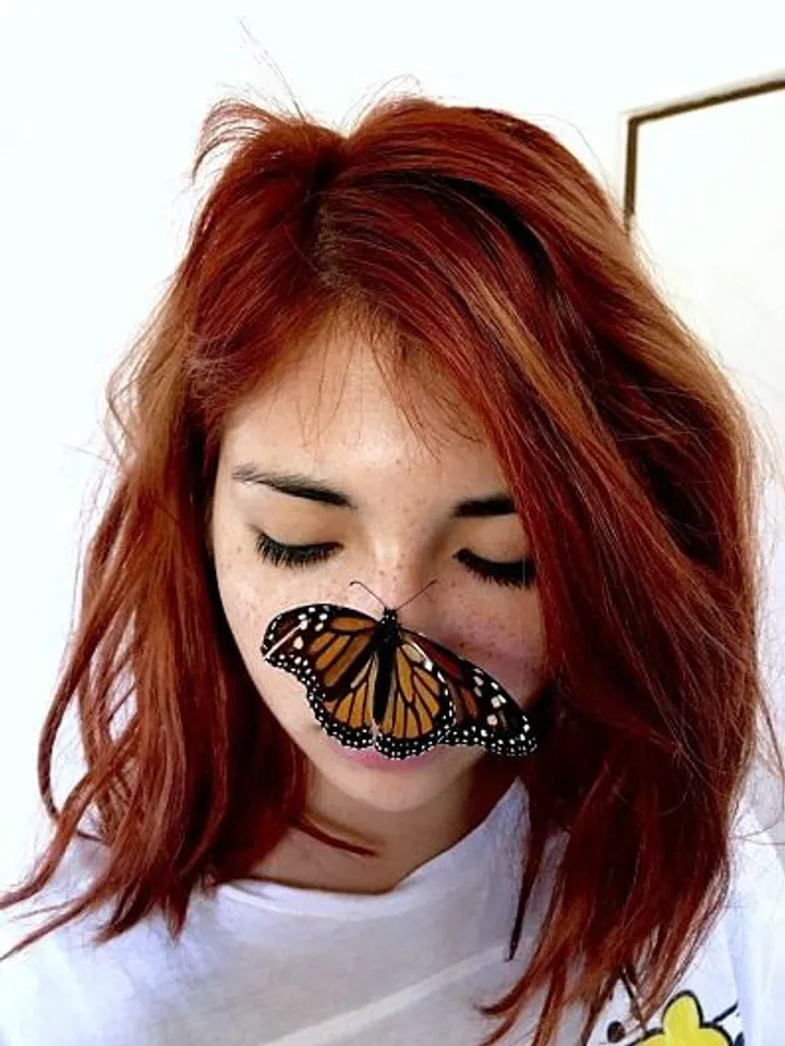 A photo of a girl and a butterfly by Melissa Casillas from Mexico
