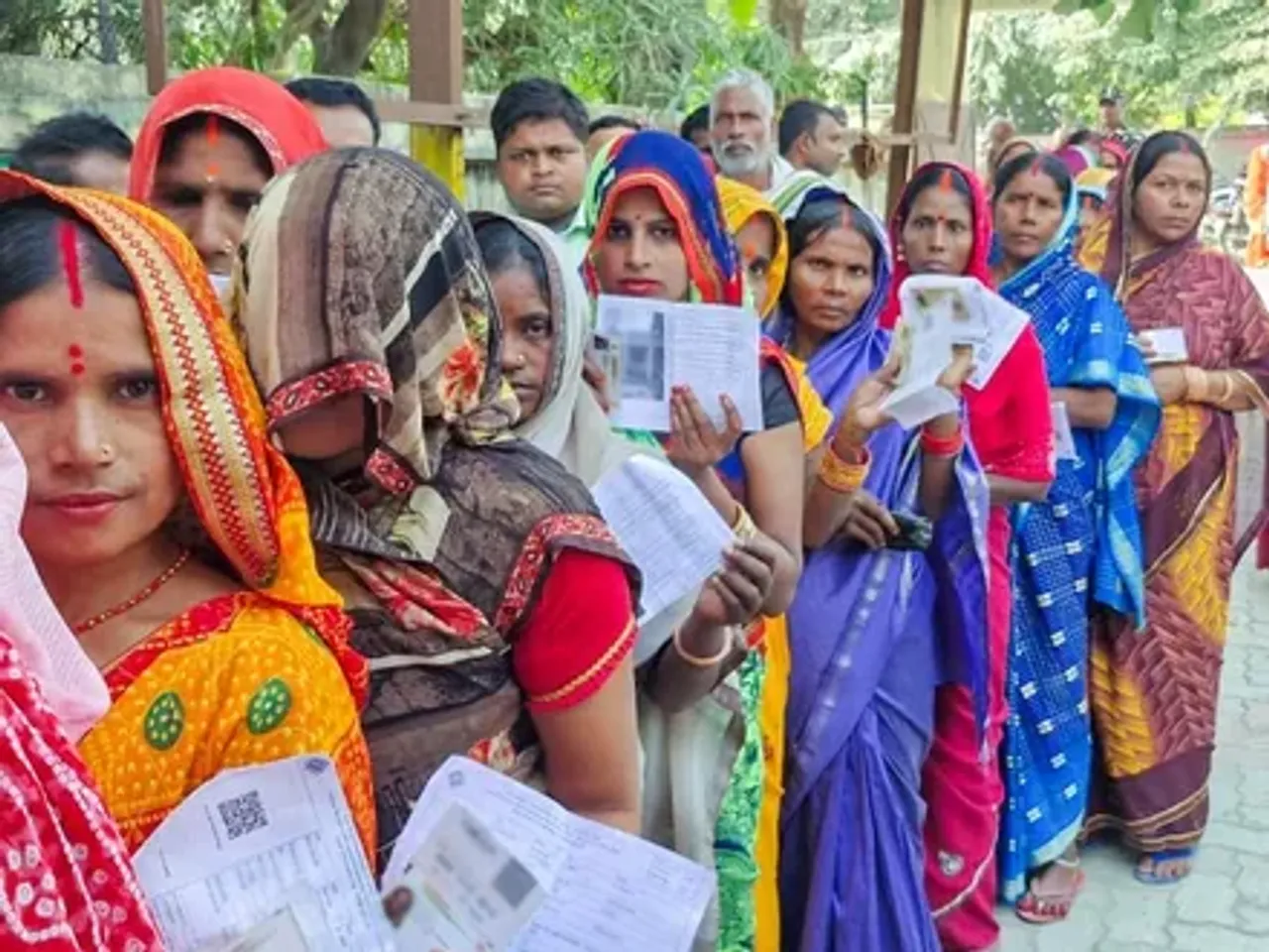 Women-voters-wait-in-a-queue-to-cast-their-vote-fo_1763007738932_1763007748895