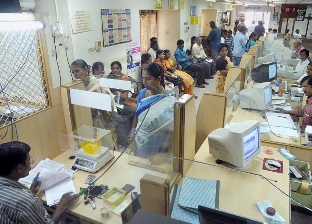 Unsung heroes: Bank staff work overtime to manage cash flow, tempers
