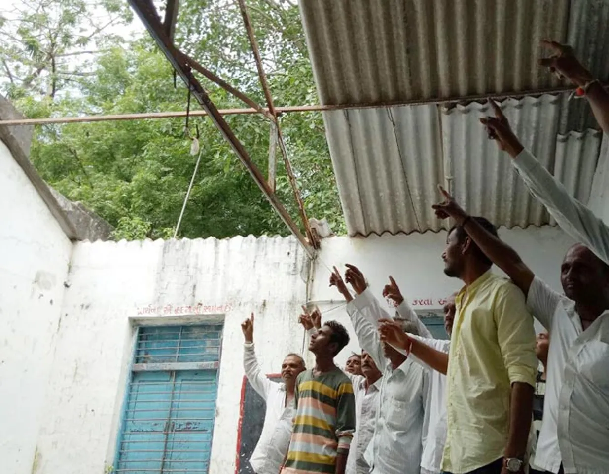 Students study under a tree in primary school near Vadodara
