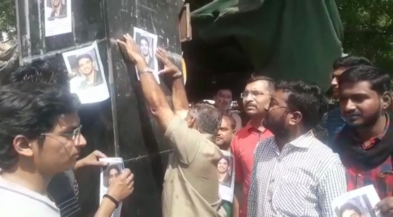 Father of missing student Devkishen Ahir stuck his posters at railway station