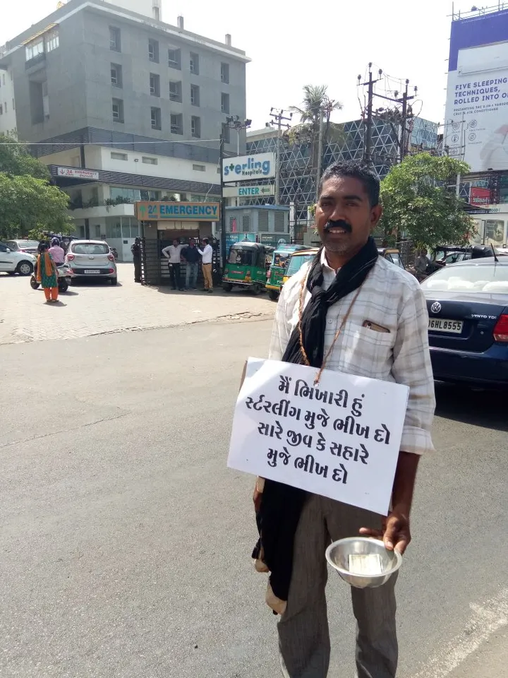 Contract employees of Sterling hospital beg outside the premises
