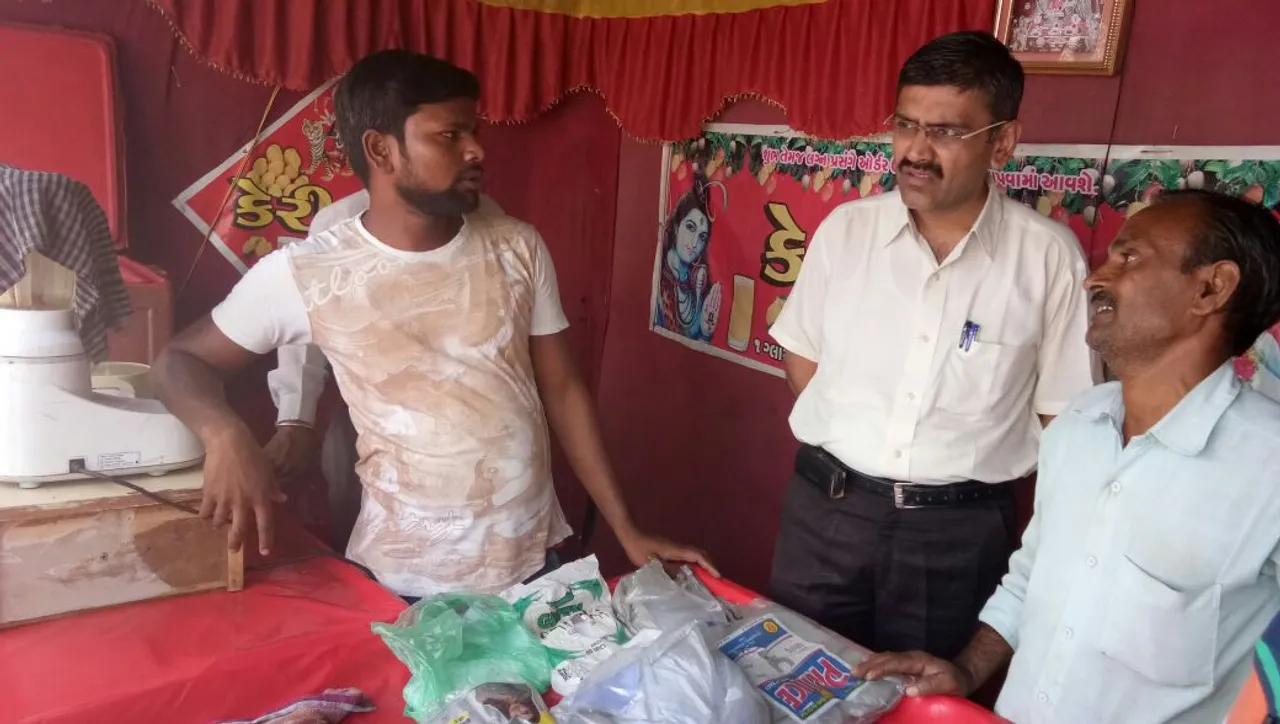 VMSS health team checking inside tents selling mango juice
