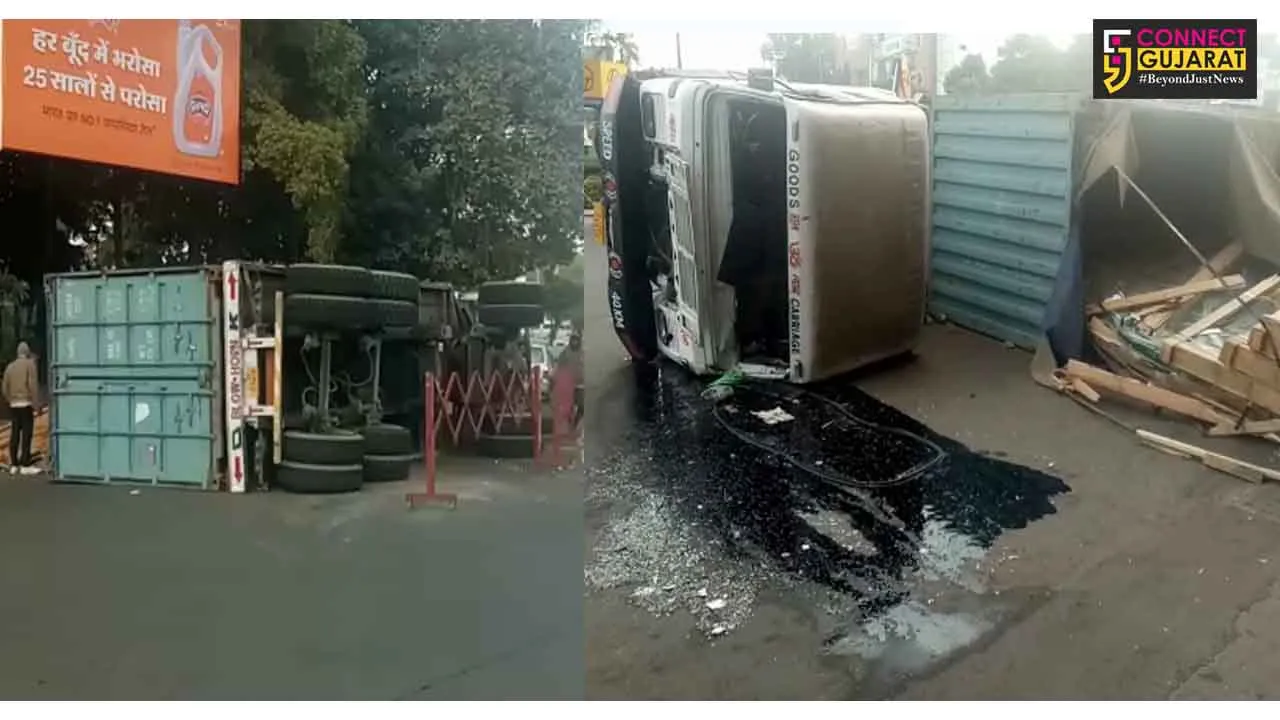 Glass laden container turned turtle near Vuda circle at Karelibaug