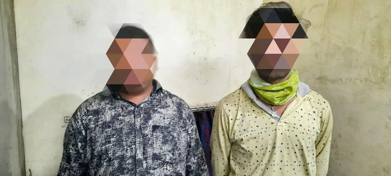 Two persons were caught with liquor hidden in a hidden pocket of a vehicle